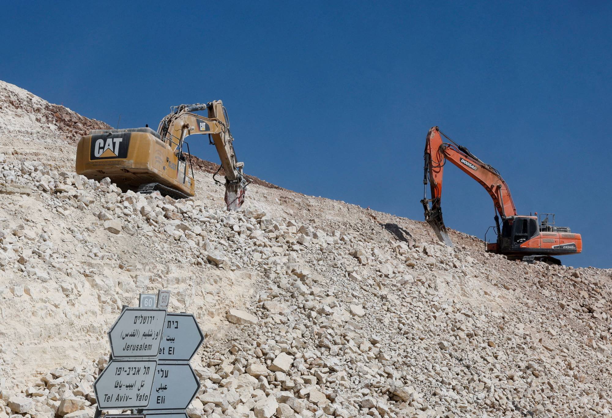 İsrail yerleşimlerini Batı Şeria'ya bağlayan bir yolu genişleten iş makineleri (Reuters)
