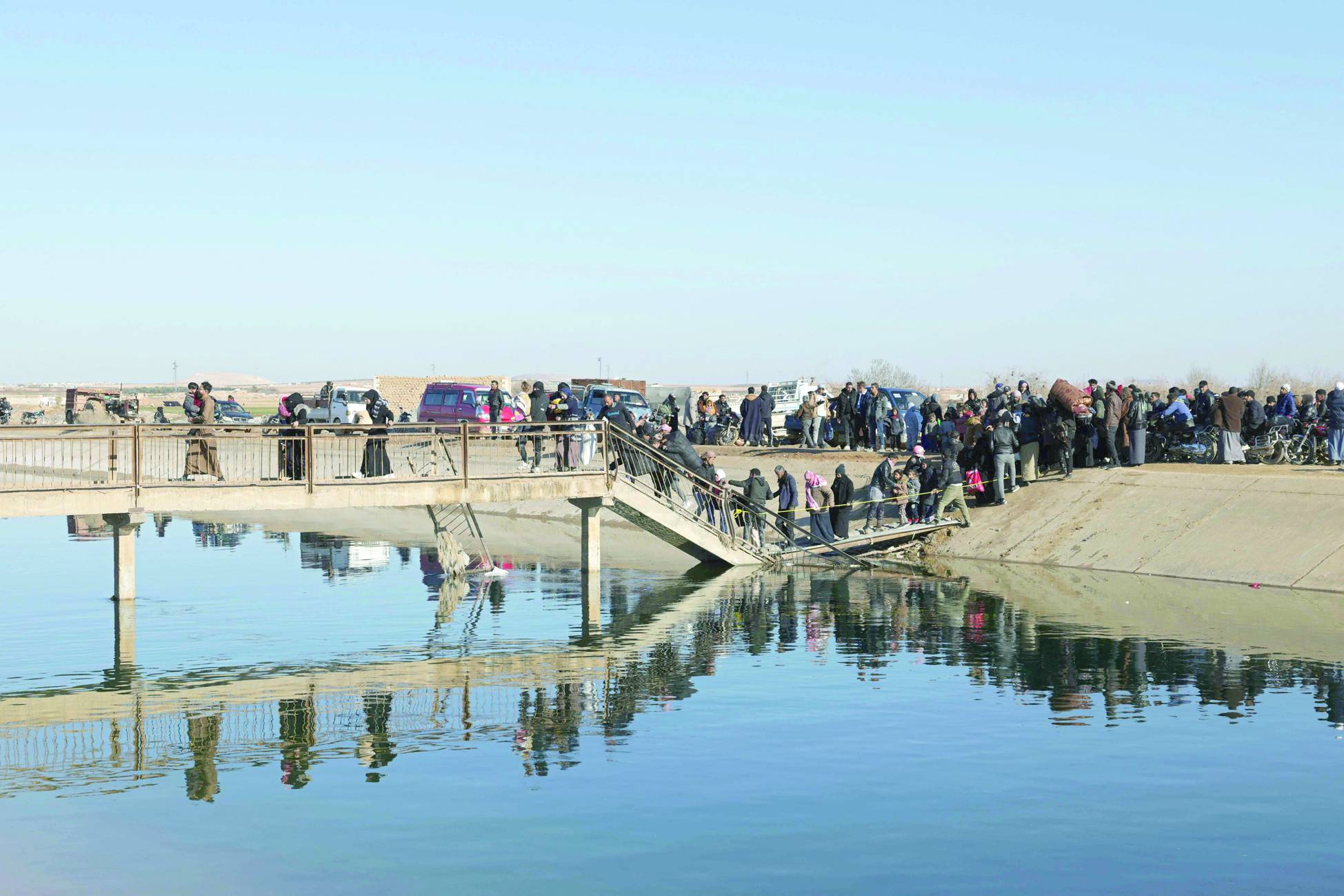  Halep'in doğusunda SDG ile Suriye ordusu arasındaki çatışma bölgelerinden kaçan siviller (AFP)