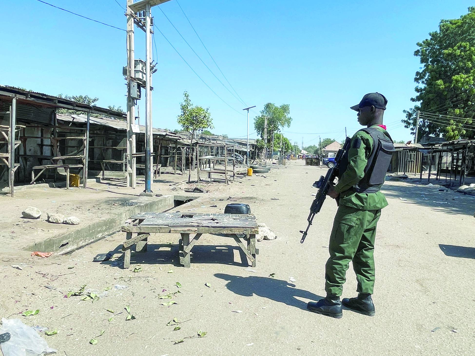 Nijerya'da, 25 Aralık 2025'te, akşam namazından sonra Maiduguri, Borno Eyaleti, Gamboru pazarı yakınlarındaki bir camide meydana gelen patlamanın ardından Nijeryalı polis memuru caminin önünde duruyor (Reuters)