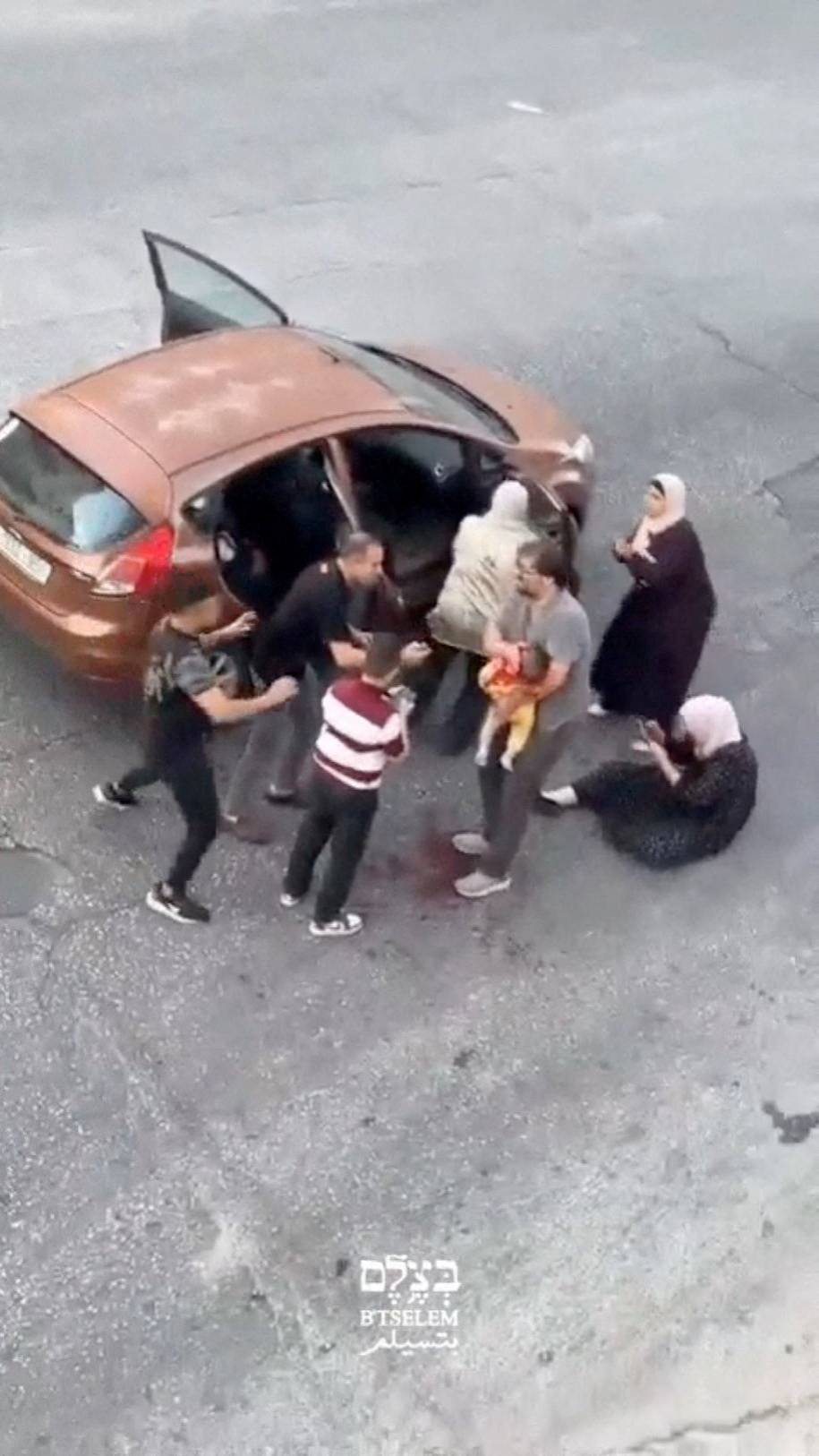 Yedi aylık Sam Fahd Ebu Heykel, işgal altındaki Batı Şeria'da bulunan el Halil’de, içinde bulundukları araca İsrail askerinin ateş açmasından birkaç dakika sonra babasının kollarında görülüyor (B'Tselem videosu- Reuters)