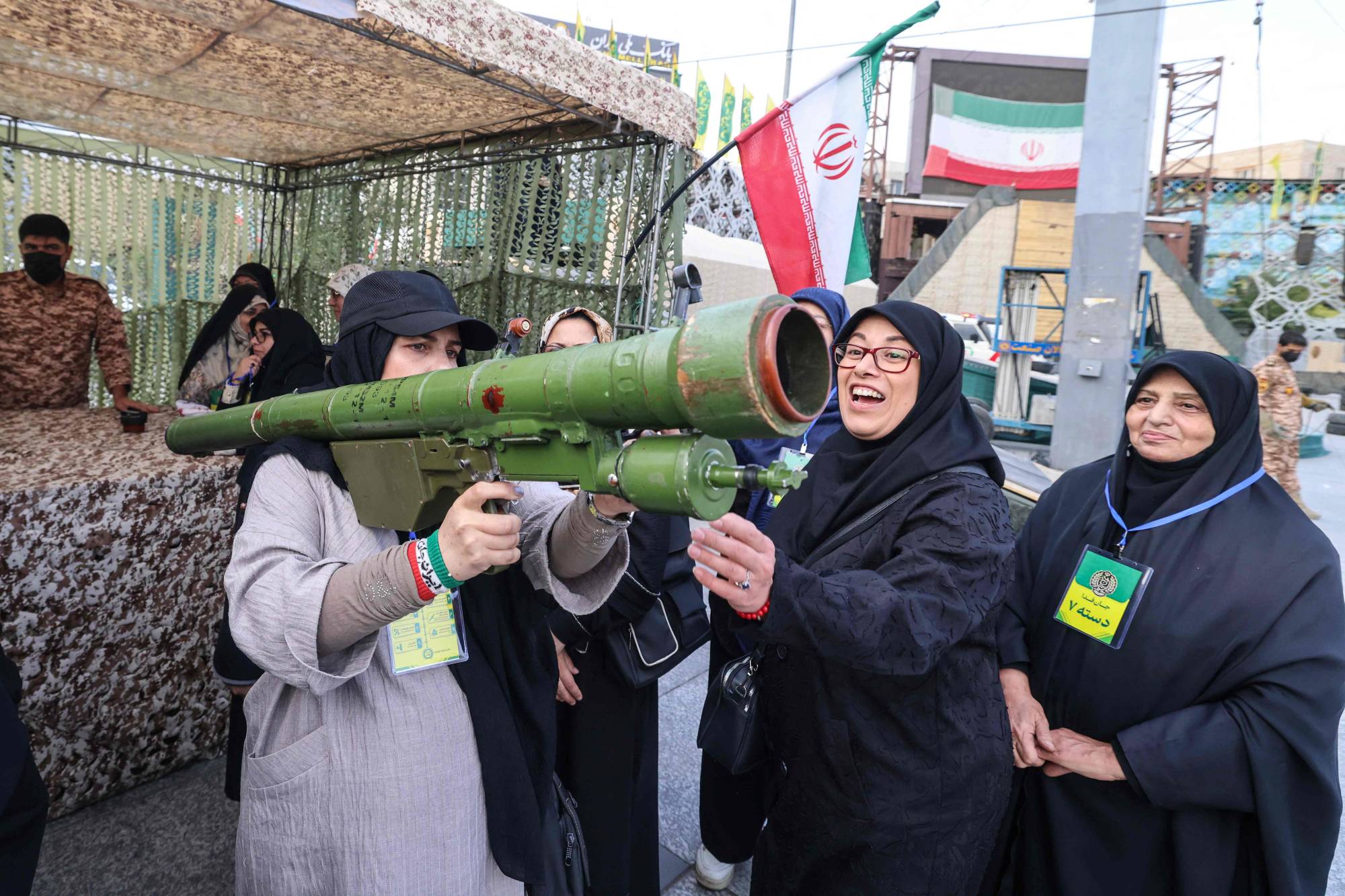 İranlı bir kadın, 6 Ekim 2026’da Tahran’daki bir eğitim kampında düzenlenen gönüllü askerî eğitim sırasında omzunda roketatar taşıyor. (AFP)