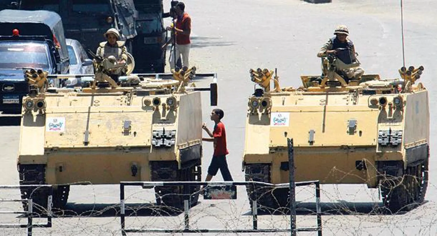 صورة أرشيفية لمدرعتين عسكريتين تابعتين للجيش المصري تغلقان أحد مداخل ميدان التحرير في القاهرة (أ.ب)