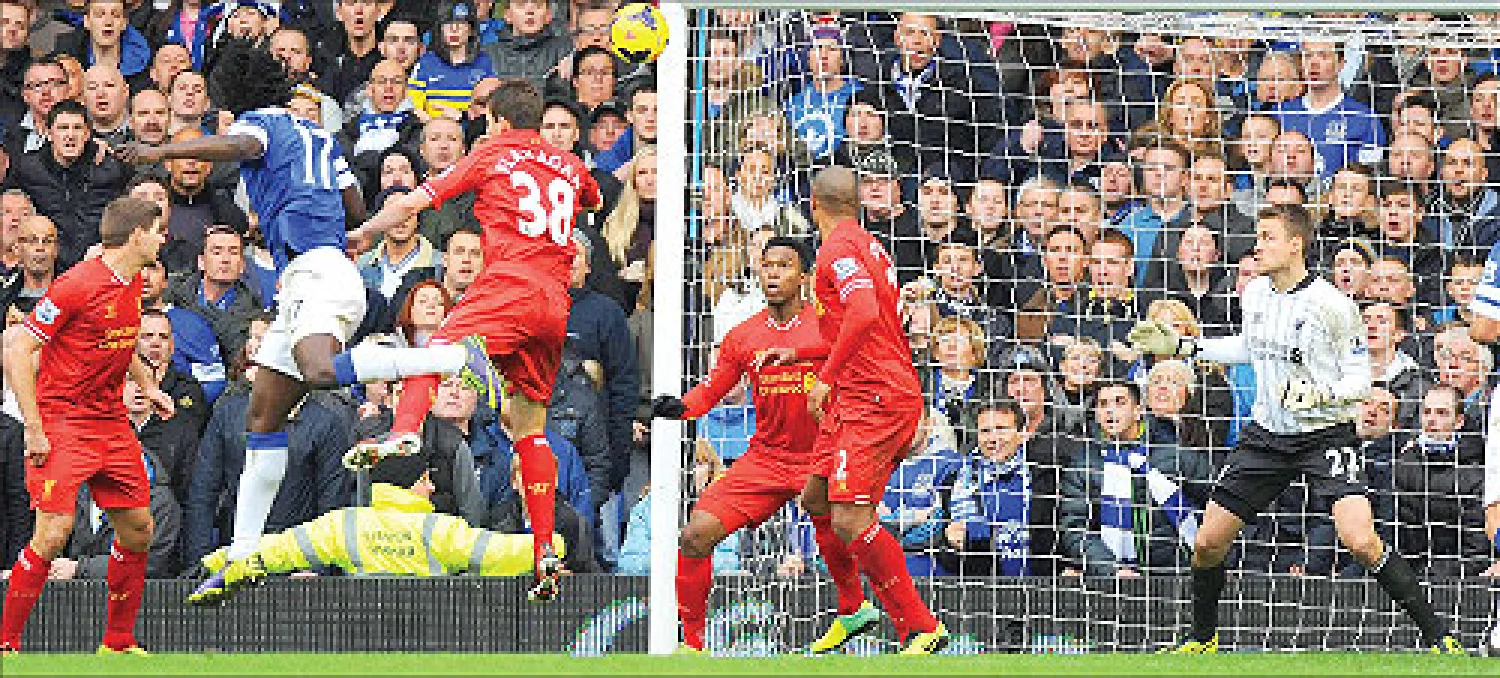 لوكاكو نجم هجوم إيفرتون (رقم 17 يسار) يسدد برأسه محرزا هدفه الثاني، والثالث لفريقه في مرمى ليفربول (إ.ب.أ)