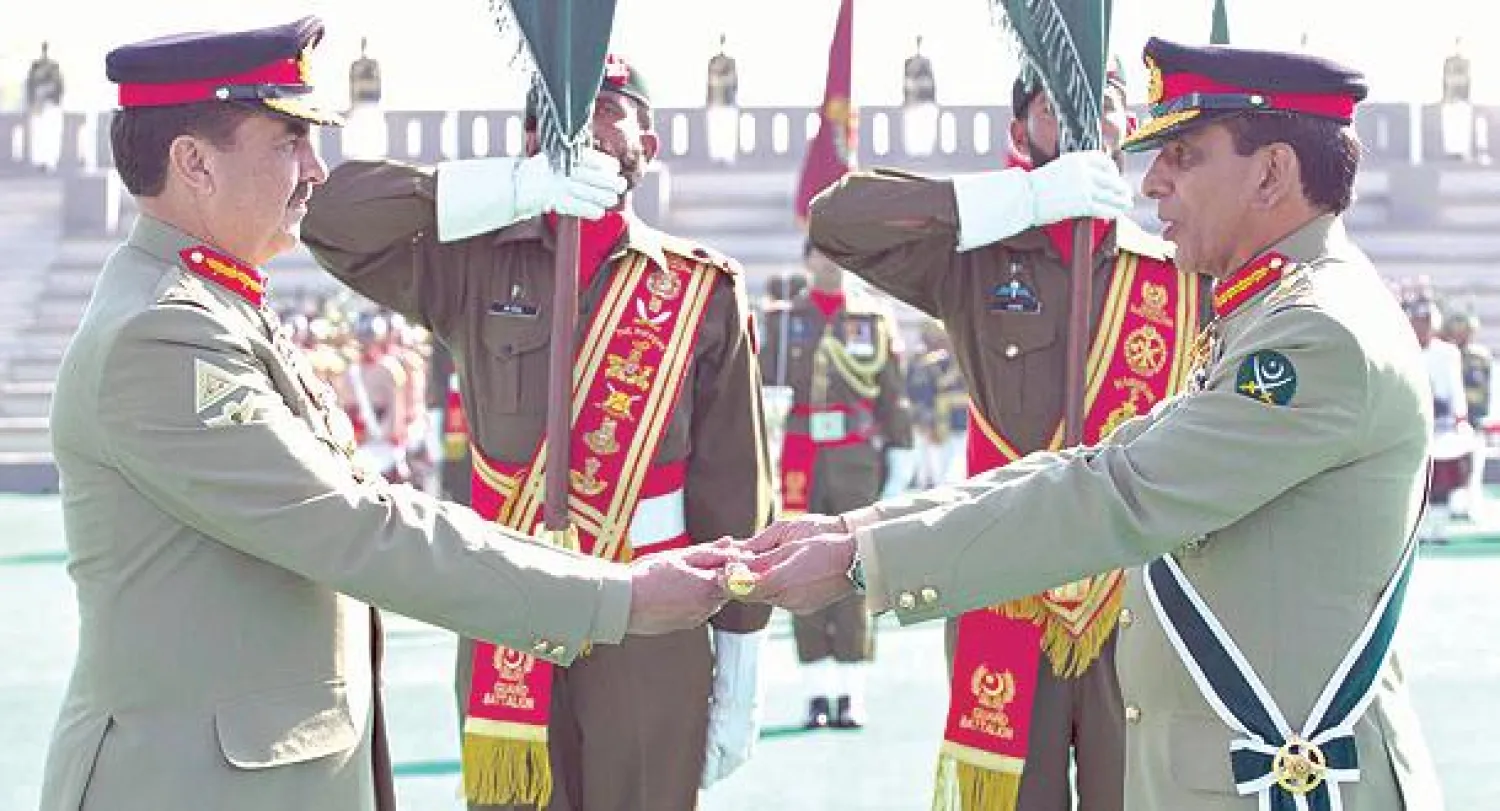 قائد الجيش المنتهية ولايته كياني (يمين) يسلم عصا القيادة لخلفه راحيل شريف، خلال حفل أداء اليمين في روالبندي أمس (رويترز)