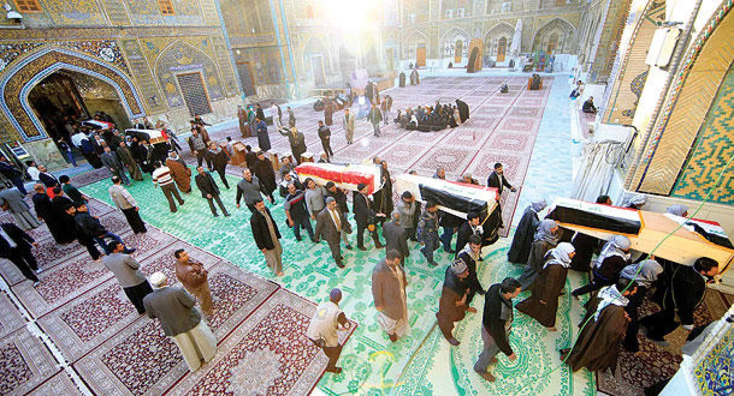 مشيعون يحملون نعوش جنود قتلوا في مواجهات بالرمادي خلال مراسم تشييعهم في النجف أمس (رويترز)