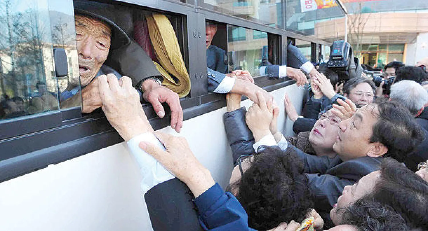 كوريون شماليون داخل الحافلة يودعون أقاربهم (الجنوبيين) بعد لقاء جمعهم لمدة ثلاثة أيام في بلدة حدودية في الأول من نوفمبر 2010 (أ.ف.ب)