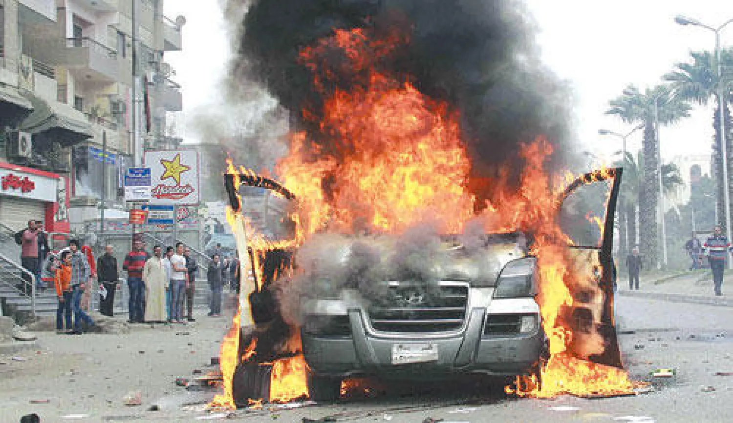 سيارة تابعة لإحدى القنوات التلفزيونية المصرية أثناء احتراقها خلال مظاهرة لأنصار الرئيس المعزول في منطقة الهرم يوم الجمعة الماضي (أ.ب)