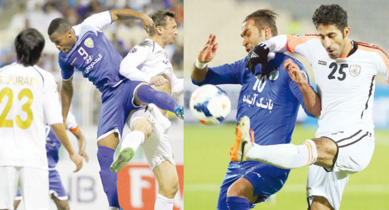 ماجد المرشدي مدافع الشباب يبعد الكرة من أمام لاعب الاستقلال الإيراني (أ.ف.ب)  -  من مباراة الفتح وبونيدكور في الأحساء (تصوير: عيسى الدبيسي)