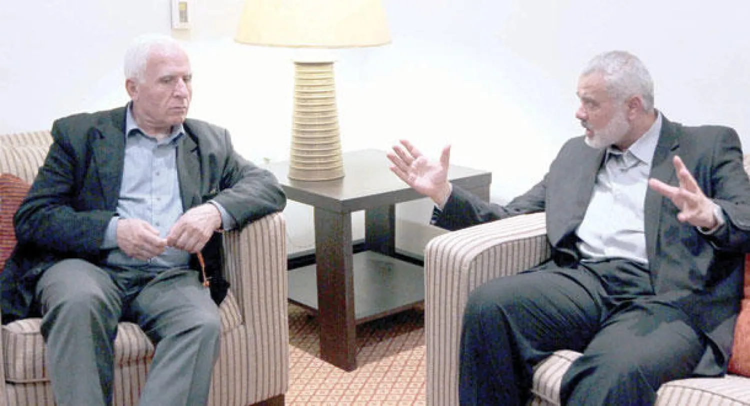 رئيس حكومة حماس المقالة اسماعيل هنية ومسؤول حركة فتح لمباحثات المصالحة عزام الأحمد في غزة أمس (أ.ف.ب)