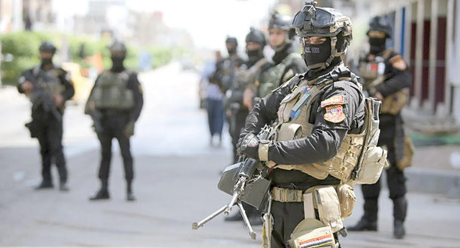 عناصر أمن عراقيون ينتشرون في محيط مركز انتخابي ببغداد أمس (أ.ف.ب)