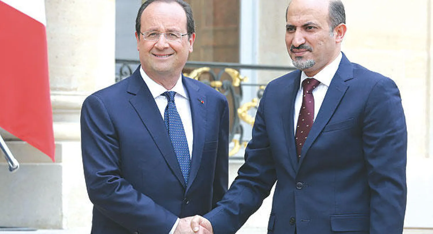 الرئيس الفرنسي فرنسوا هولاند رئيس الائتلاف السوري أحمد الجربا لدى لقائهما في باريس أمس (أ.ب)