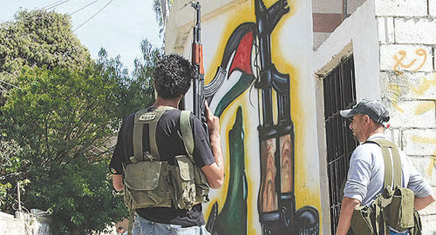 صورة أرشيفية لمقاتلين من حركة فتح خلال مناوشات في مخيم المية ومية  للاجئين الفلسطينيين في مدينة صيدا (أ.ب)