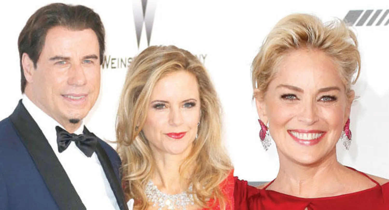 شارون ستون (رويترز)  -  جون ترافولتا مع زوجته كيلي بريستون (إ.ب.أ)