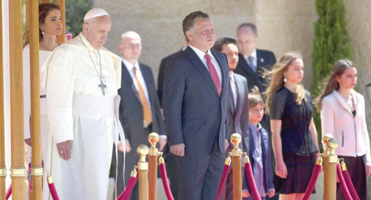 العاهل الأردني الملك عبد الله الثاني لدى استقباله بابا الفاتيكان فرنسيس الأول في القصر الملكي بعمان أمس (إ.ب.أ)