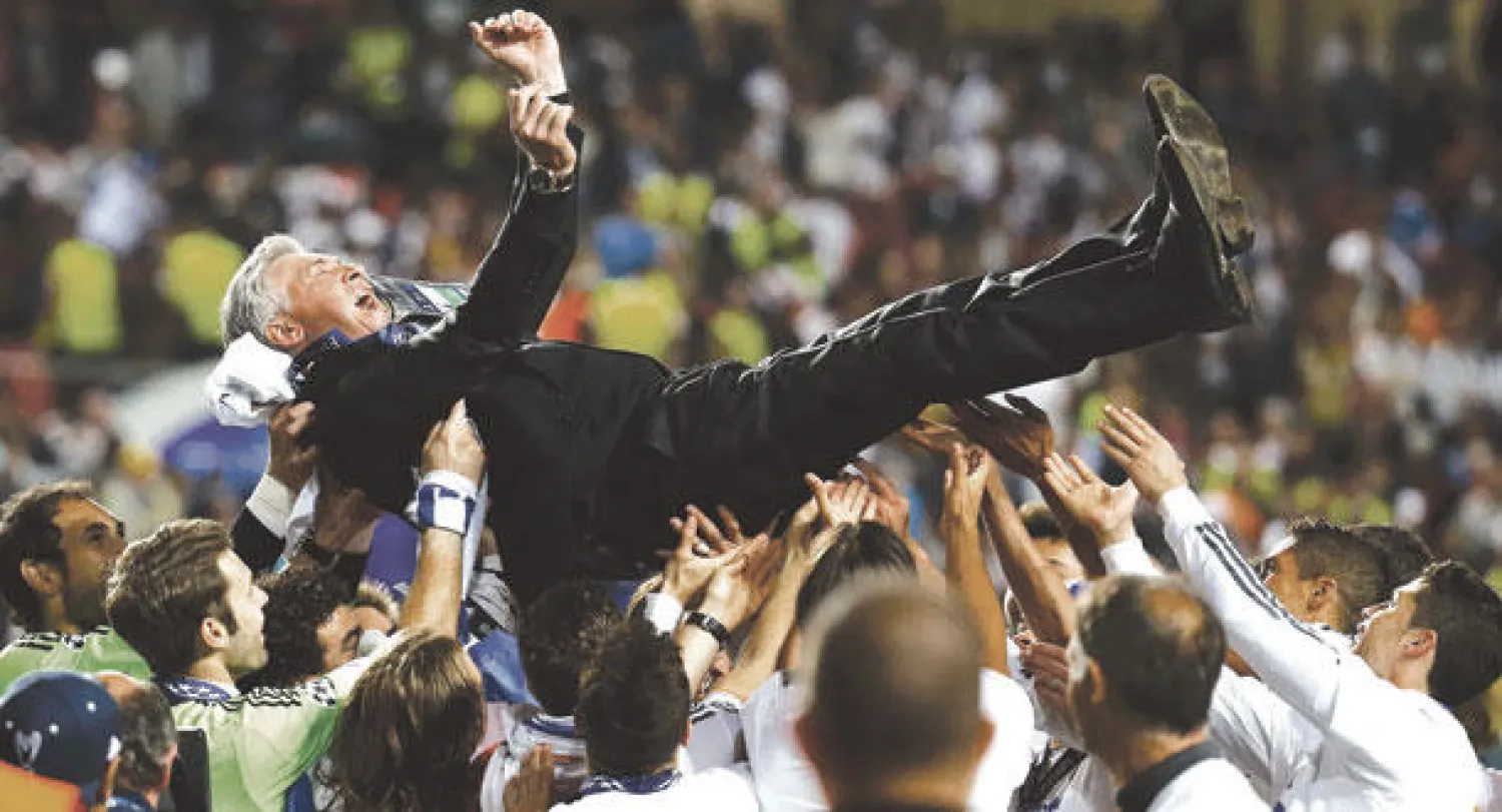 لاعبو ريـال مدريد يحتفون بمدربهم انشيلوتي برميه في الهواء بعد حصد اللقب الأوروبي العاشر (رويترز)