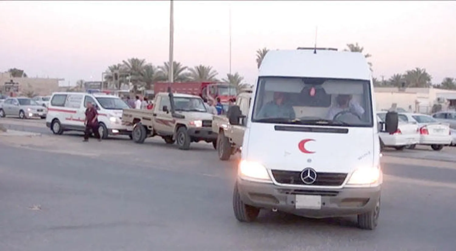 سيارة إسعاف في طريقها لتوصيل جثمان عنصر من منظمة الصليب الأحمر قتل بيد مسلحين قرب مدينة سرت الليبية أمس (أ.ب)