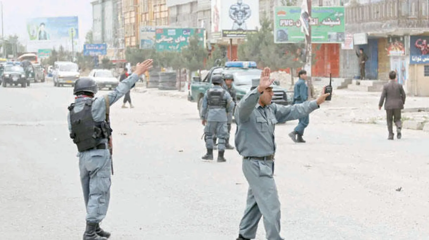 عناصر أمن توقف حركة المرور بعد تعرض موكب المرشح الرئاسي عبد الله عبد الله إلى تفجيرين أحدهما انتحاري في كابل أمس (أ.ب)