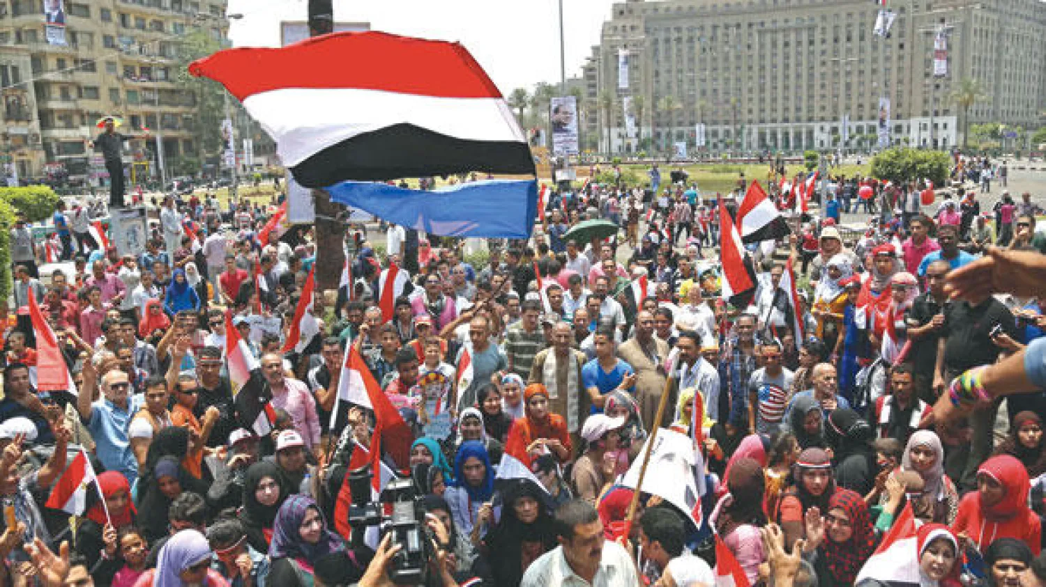 مصريون في ميدان التحرير بوسط القاهرة احتفالا بتسليم السلطة أمس (إ.ب.أ)