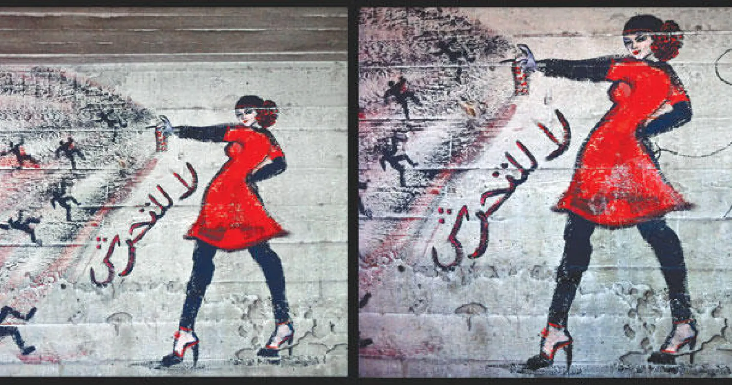 رسم جداري في ضاحية الزمالك غرب القاهرة يمثل فتاة تتصدى للمتحرشين (أ.ب)