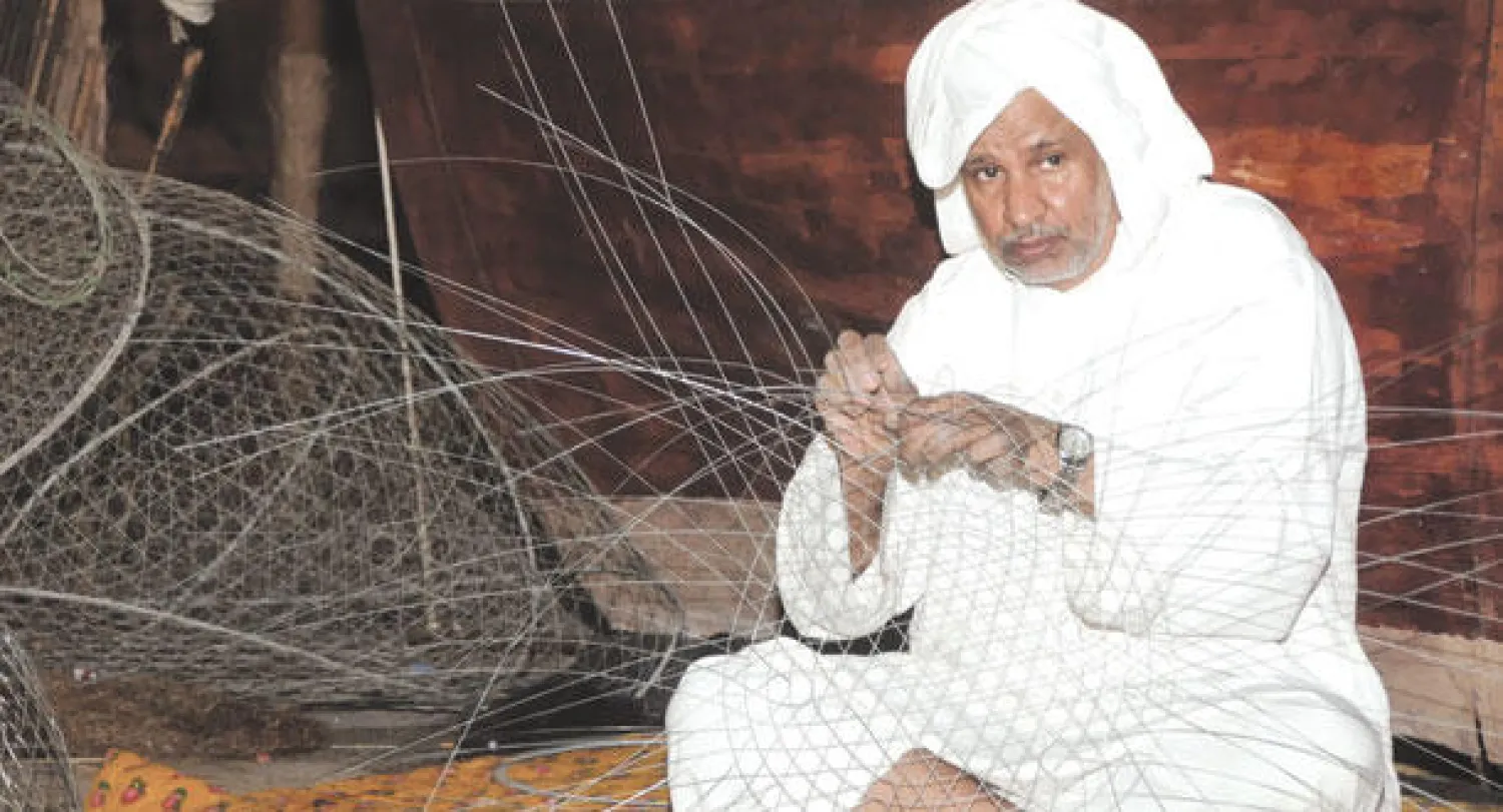 حرفي يصنع أدوات لصيد السمك في المنطقة الشرقية («الشرق الأوسط»)