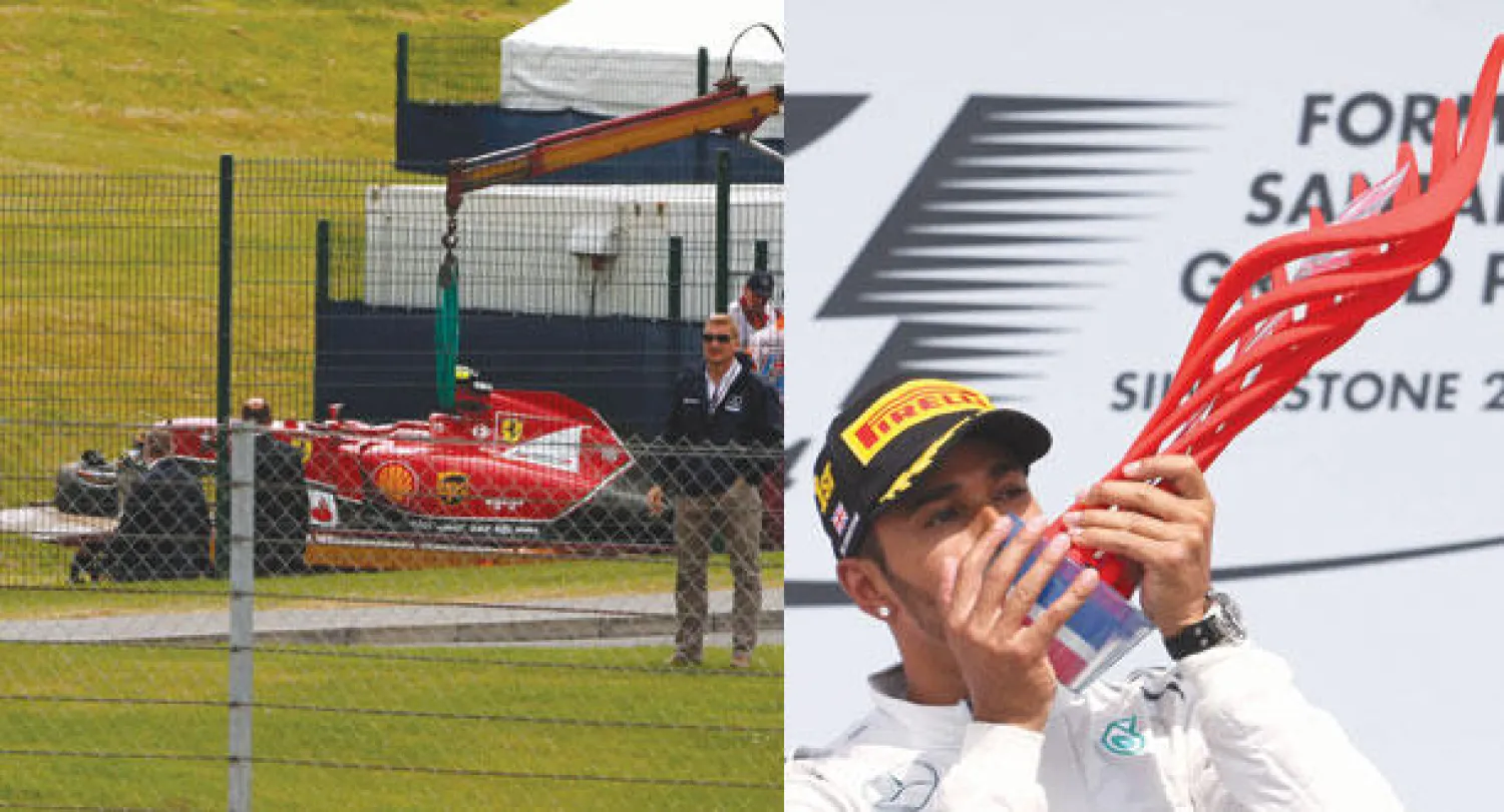 هاميلتون يحتفل بجائزة بريطانيا الكبرى (رويترز)  -  سيارة رايكونن ترفع من على حافة المضمار بعد الحادثة (رويترز)