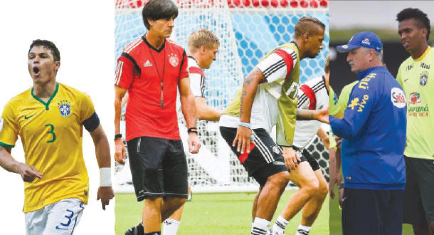 سكولاري يوجه لاعبيه خلال التدريب الأخير قبل مواجهة ألمانيا (أ.ف.ب)  -  لوف مدرب ألمانيا يتوسط لاعبيه خلال التدريبات قبل مواجهة البرازيل (إ.ب.أ)  -  إيقاف تياغو سيلفا ضربة قوية لدفاع البرازيل