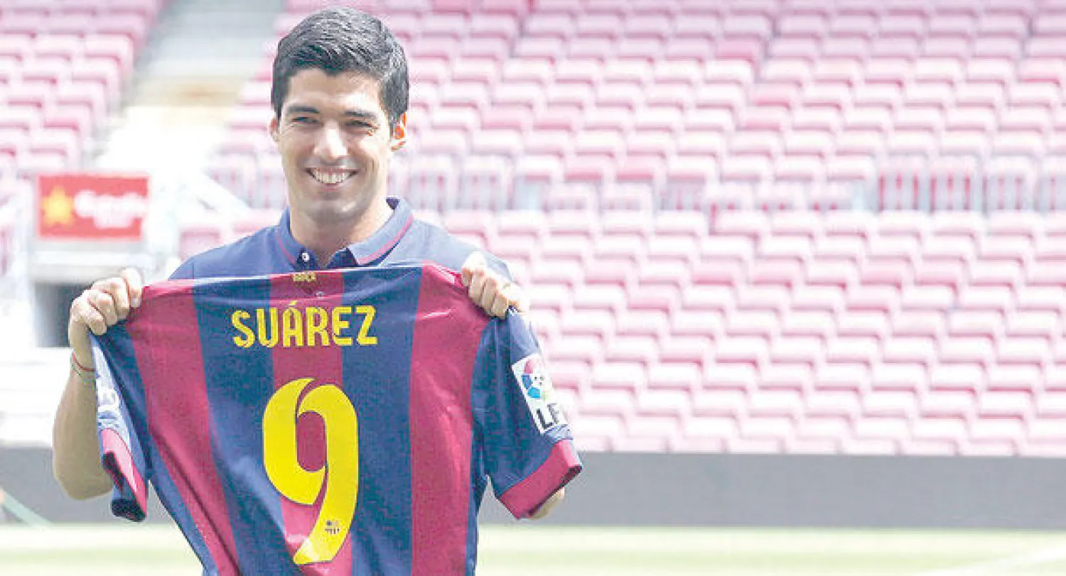 سواريز مع قميص برشلونة الجديد (رويترز)