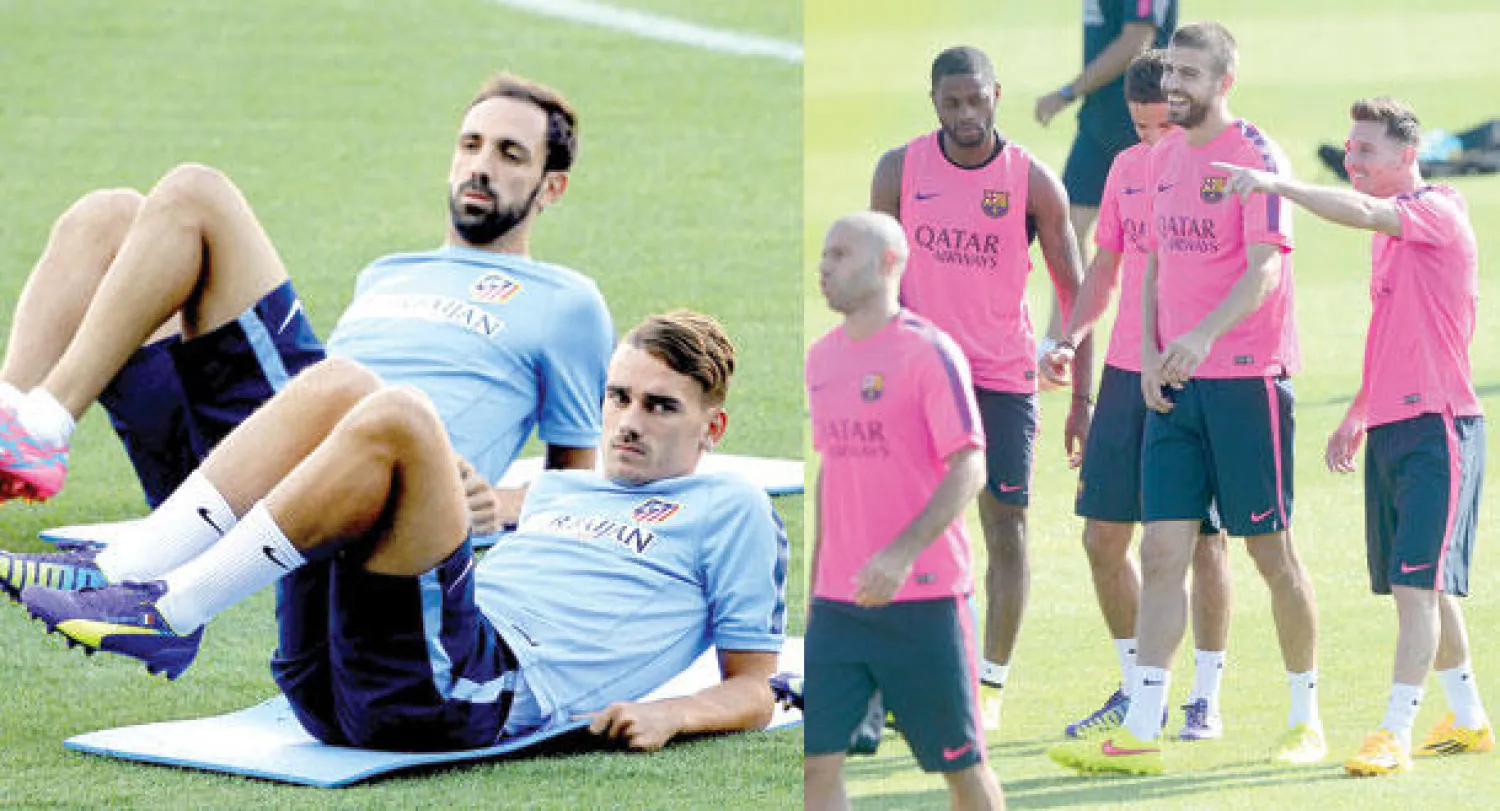 أجواء مرحة بين لاعبي برشلونة في مركز تدريبات الفريق (أ.ف.ب)  -  الفرنسي غريزمان والإسباني خوان توريس أثناء تدريبات أتلتيكو مدريد (إ.ب.أ)