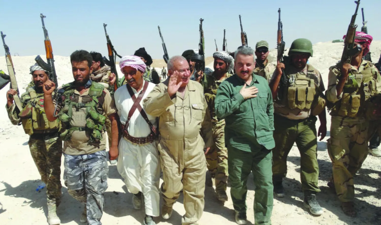 محافظ الأنبار أحمد الدليمي (الثالث من اليمن) لدى زيارته مع مسؤولين أمنيين وشيوخ عشائر موقعا أمنيا قرب حديثة أول من أمس قبل إصابته بجروح في سقوط قذيفة هاون أطلقها مسلحو «داعش» (أ.ف.ب)