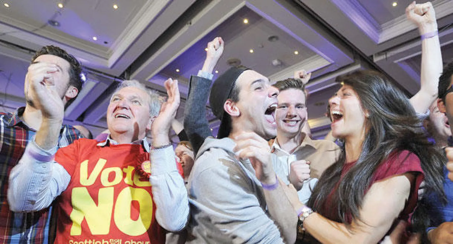 اسكوتلنديون رافضون للانفصال عن المملكة المتحدة يحتفلون بعد ظهور نتائج الاستفتاء في غلاسكو أمس (أ.ف.ب)