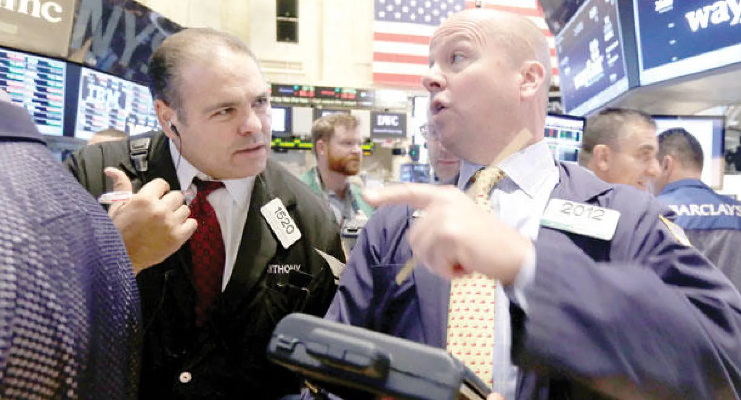 متعاملون في سوق نيويورك أمس (أ.ب)