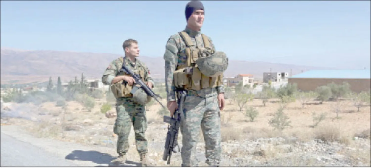 عنصران من الجيش اللبناني يقومان بالحراسة قرب قرية حدودية (أ.ب)