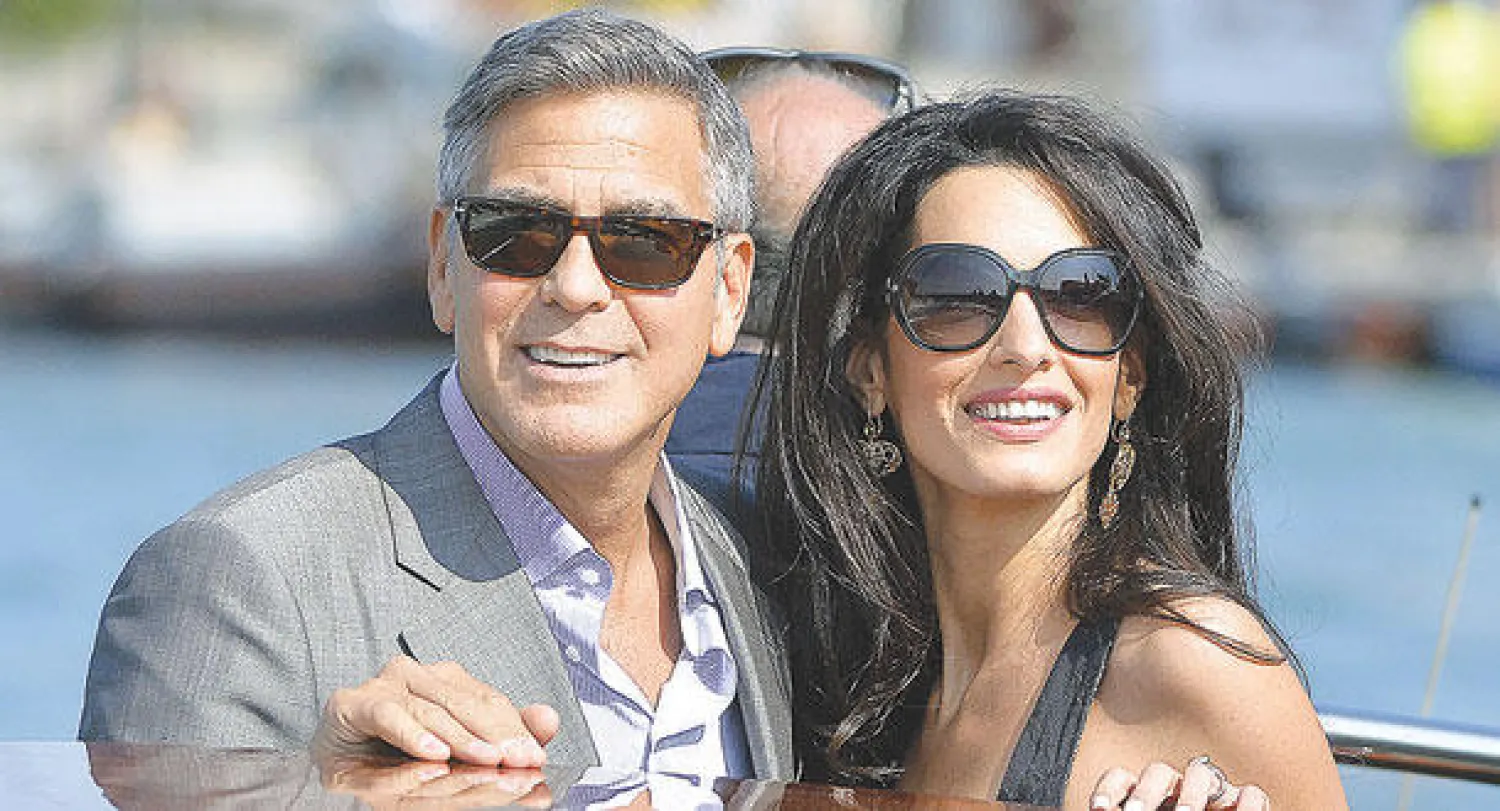 كلوني وأمل علم الدين استحوذا على اهتمام الصحافة البريطانية (أ. ف. ب)