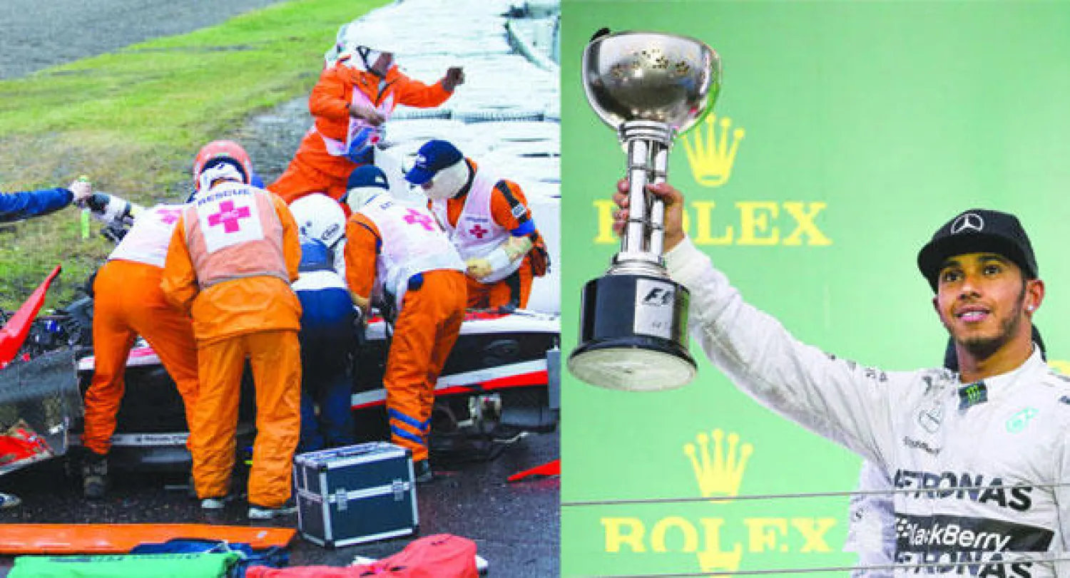 هاميلتون يستعرض كأس سباق اليابان دون احتفال متأثرا بحادث بيانكي (إ.ب.أ)  -  رجال الإسعاف يحملون الفرنسي بيانكي بعد الحادثة الخطيرة التي تعرض لها (إ.ب.أ)