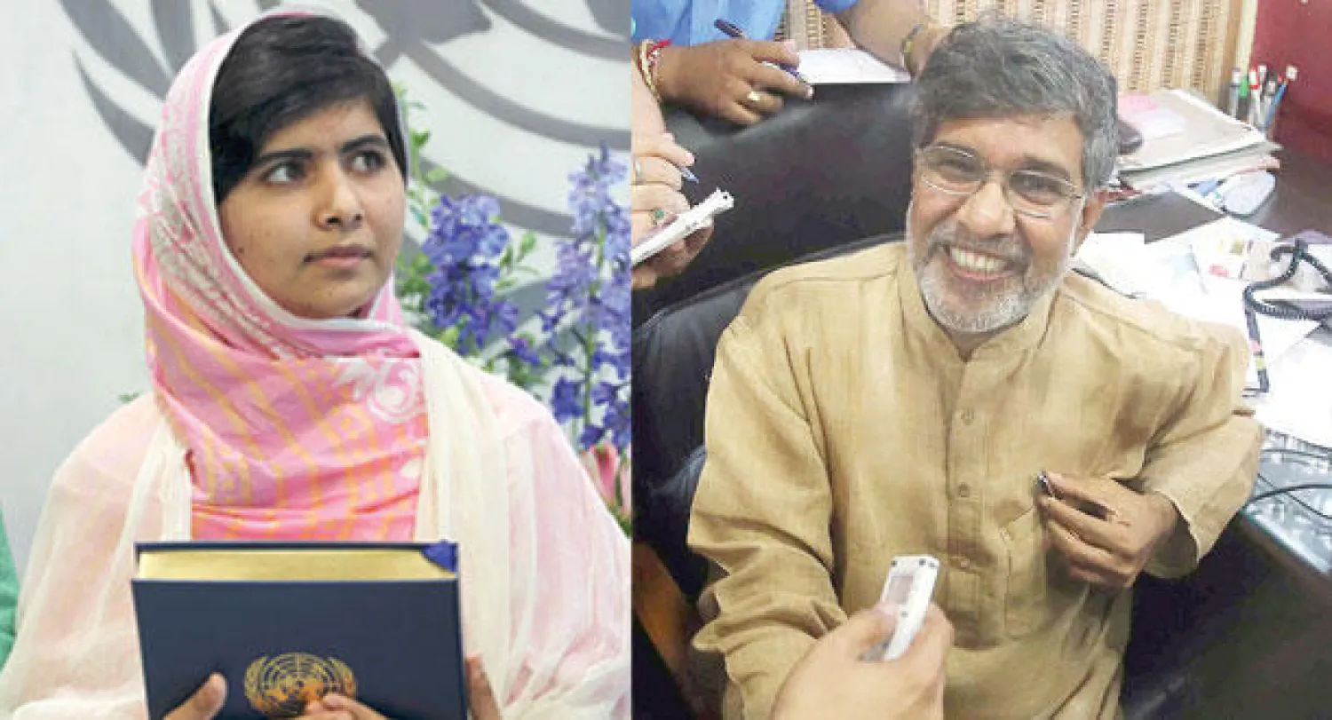 كايلاش ساتيارثي (إ.ب.أ)  -  ملالا يوسف زاي تحمل نسخة من ميثاق الأمم المتحدة (أ.ب)
