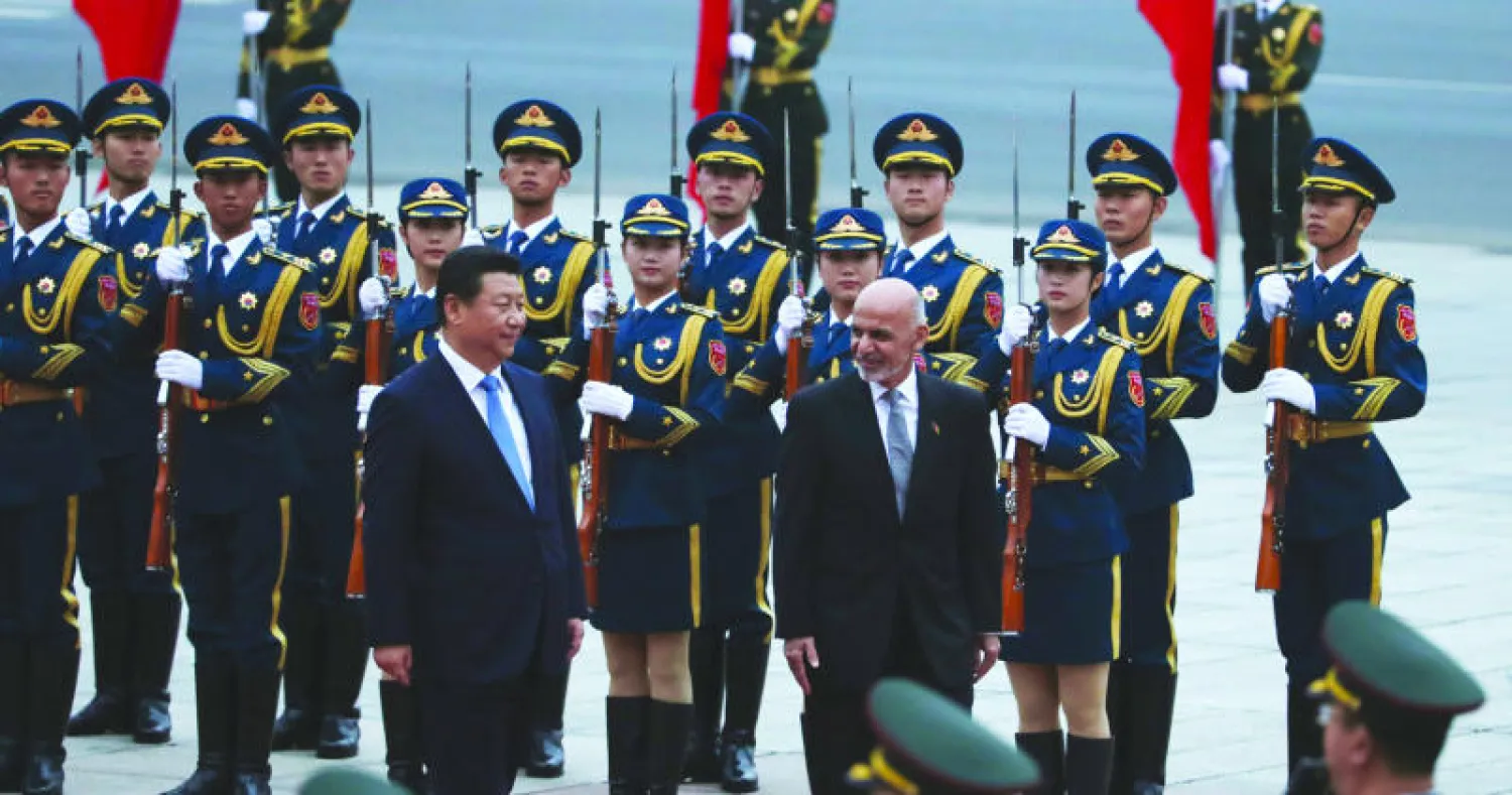 الرئيسان تشي وغني يستعرضان حرس الشرف خلال حفل استقبال في قصر الشعب ببكين أمس (أ.ب)