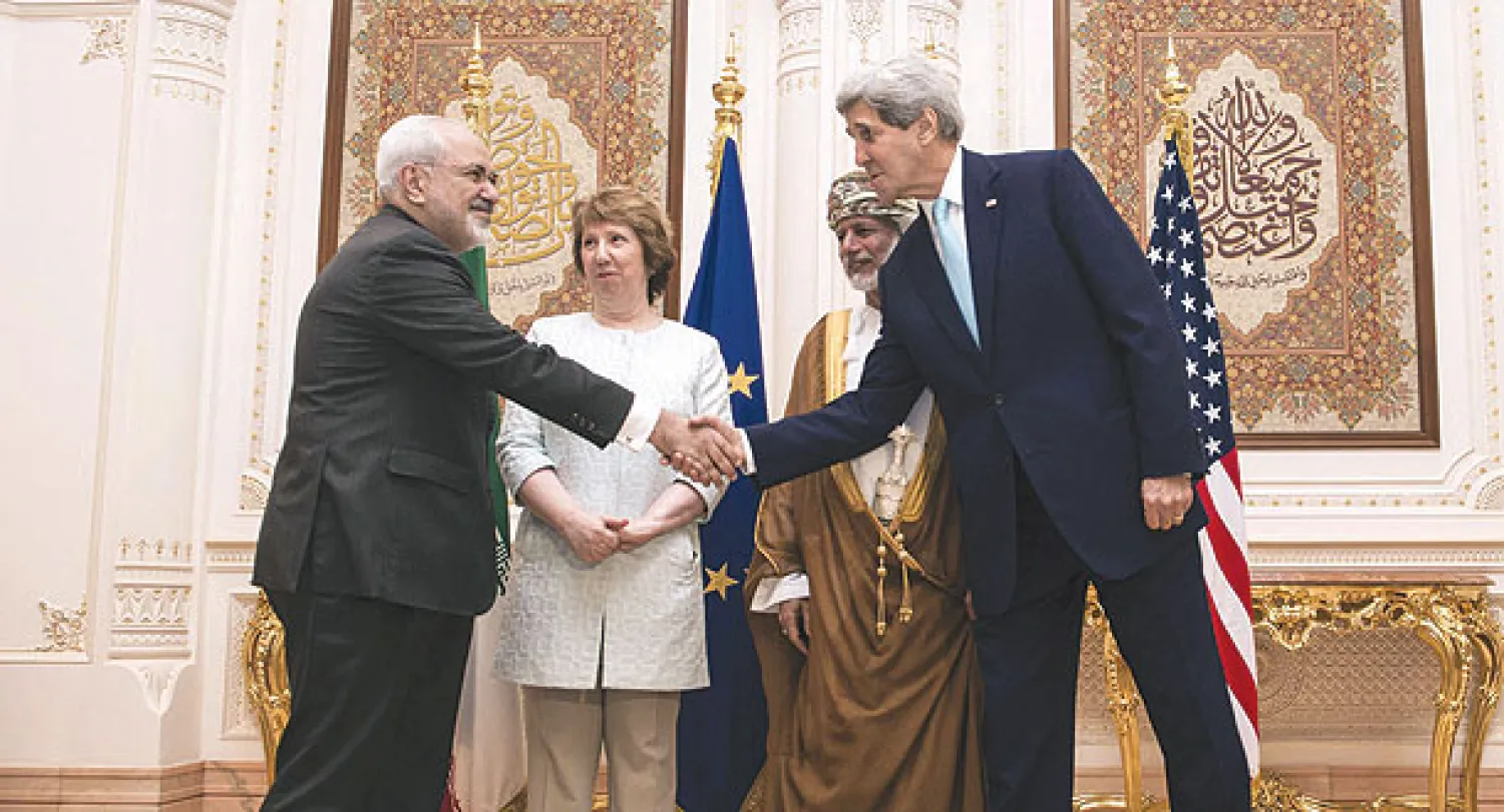 وزير الخارجية الأميركي يصافح نظيره الإيراني بحضور وزير خارجية عمان ومبعوثة الاتحاد الأوروبي في مسقط أمس (أ.ف.ب) 