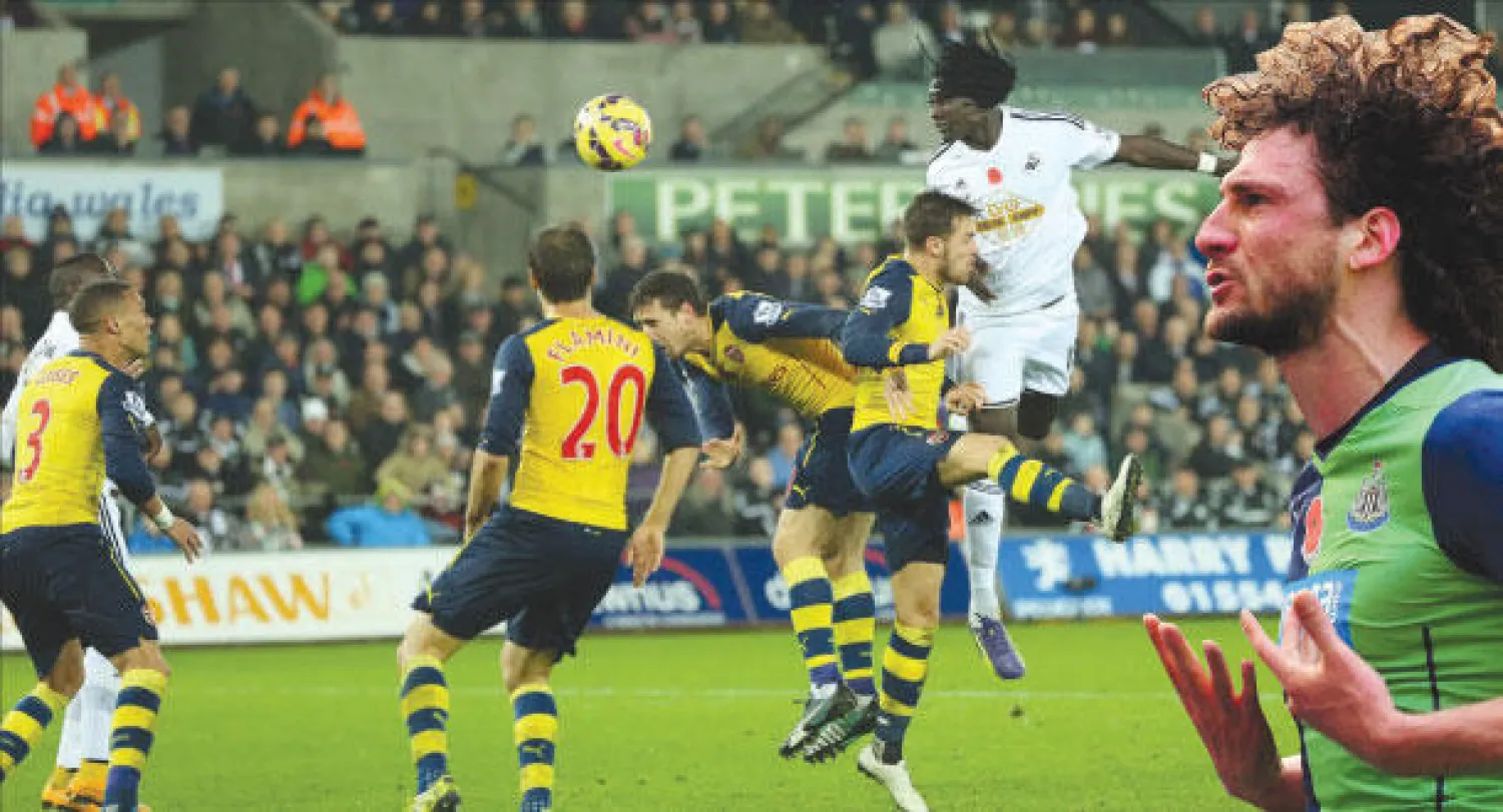 الأرجنتيني كولوتشيني (يمين) يعزز تقدم نيوكاسل (أ.ف.ب) الفرنسي غوميس محاطا بمدافعي آرسنال يحرز هدف الفوز لسوانزي (إ.ب.أ)