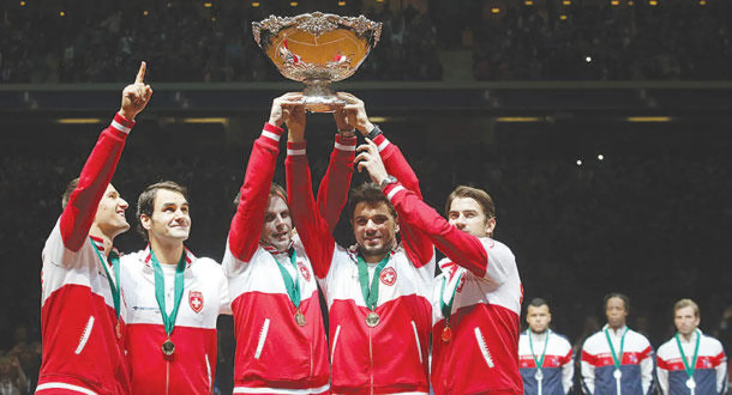 فيدرر (الثاني من اليسار) يشارك الفريق السويسري الاحتفال بكأس ديفيز (أ.ب)