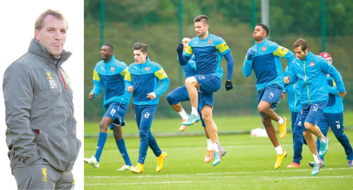 لاعبو آرسنال يخوضون التدريبات أمس استعدادا للمواجهة الصعبة مع دورتموند (رويترز)  -  مستقبل رودريغز مدرب ليفربول أصبح على المحك (إ.ب.أ)