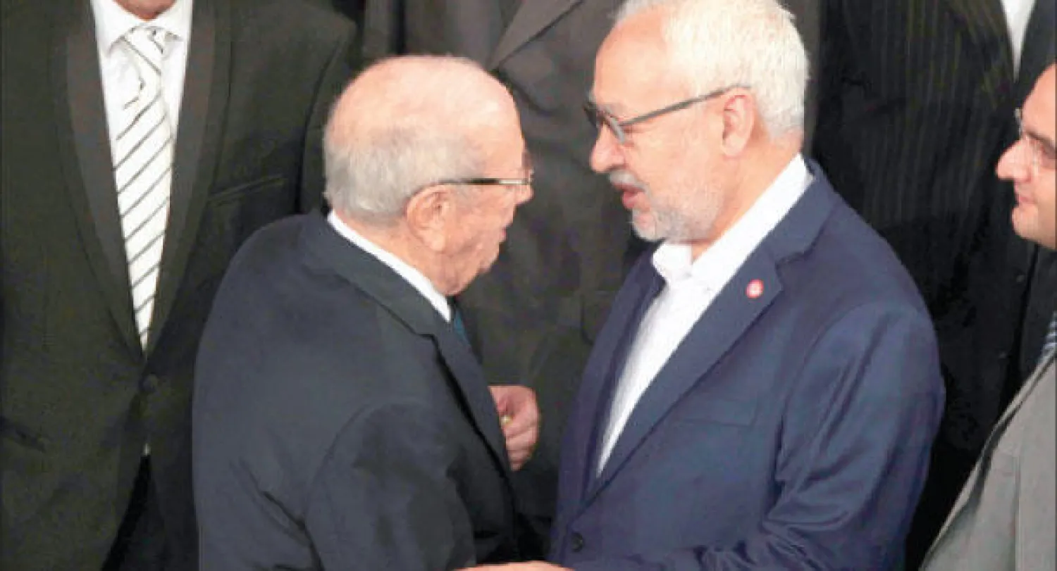 زعيما «نداء تونس» و«النهضة» بعد انتهاء الجلسة الأولى للبرلمان التونسي الجديد أمس (رويترز)