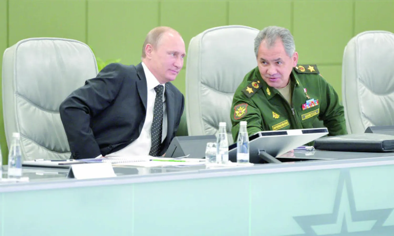 بوتين ووزير دفاعه سيرغي شويغو أثناء الاجتماع مع كبار الضباط في موسكو مساء أول من أمس (رويترز)