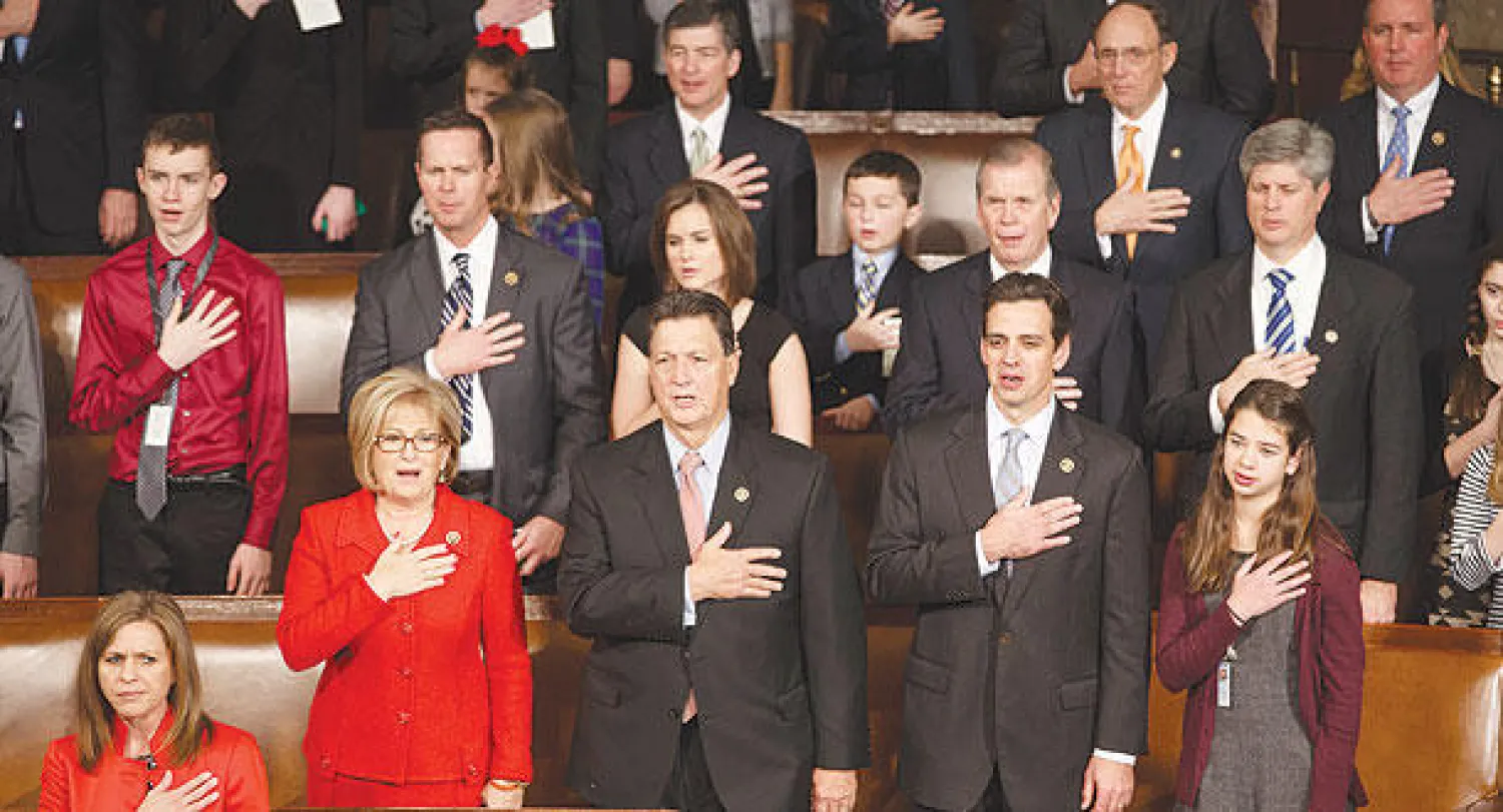 أعضاء في مجلس النواب، بعضهم رفقة عائلاتهم، يؤدون قسم الولاء لدى افتتاح الدورة الـ114 من دورات الكونغرس في «الكابيتول هيل» أمس (أ.ب)