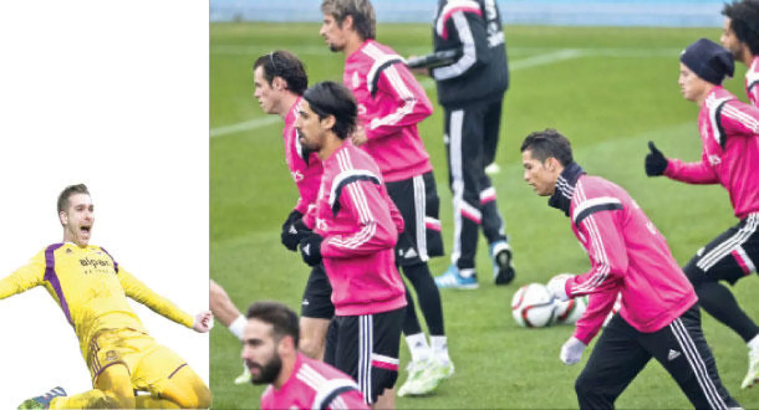 رونالدو نجم ريـال مدريد يتوسط زملاءه في الفريق خلال تدريبات الأمس قبل مواجهة أتليتكو (إ.ب.أ)  -  أدريان حارس وستهام يحتفل بتسديدته الناجحة لركلة الترجيح (أ.ف.ب)