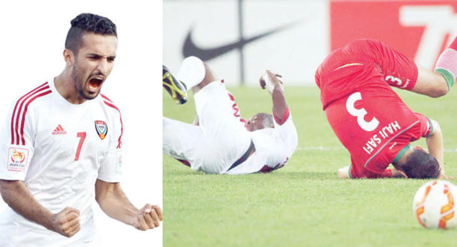 اصطدام عنيف بين لاعبين من قطر وإيران في المباراة التي جمعت المنتخبين أمس (رويترز)  -  الإماراتي علي مبخوت يحتفل بهدفه في البحرين (أ.ف.ب)