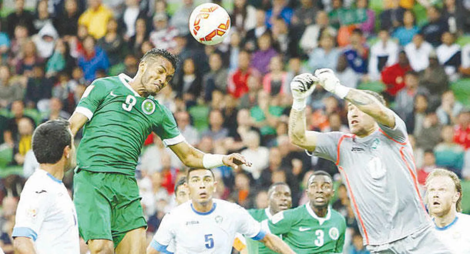 نايف هزازي يرتقي للكرة في إحدى الهجمات السعودية (رويترز)