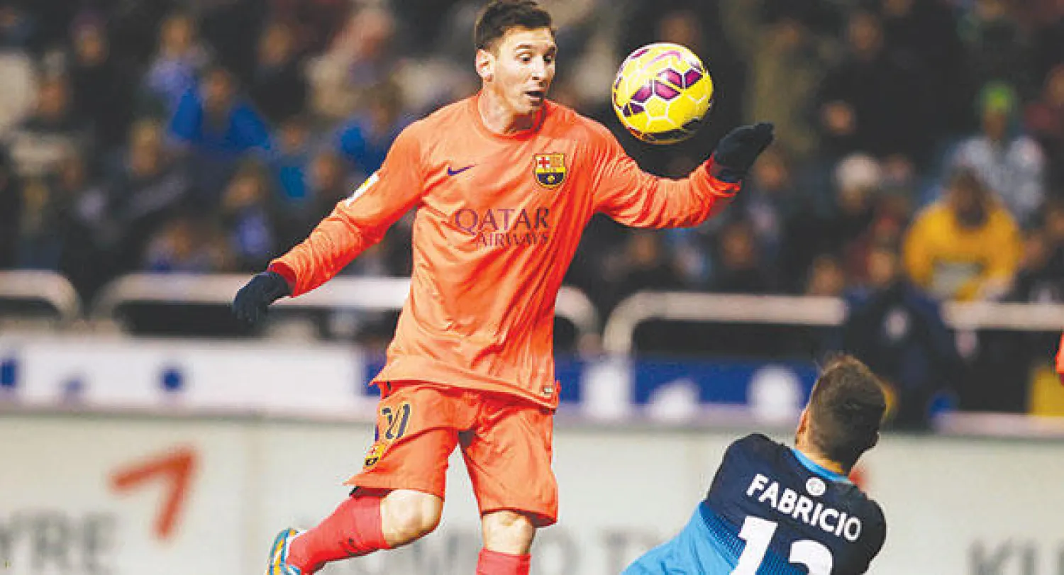 ميسي يسدد من فوق حارس ديبورتيفو ليسجل واحدا من ثلاثيته (رويترز)