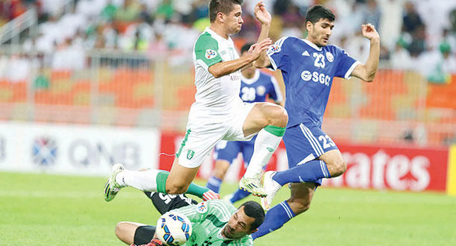 حارس السد يبعد الكرة قبل أن تصل إلى رأس الكوري كواك  من الهلال (تصوير: علي العريفي)