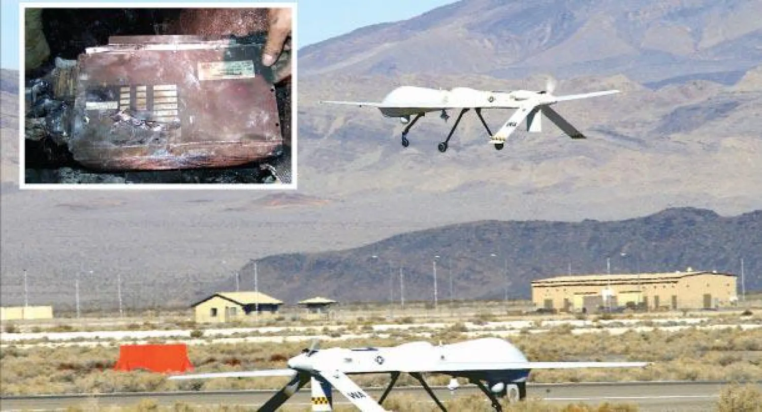 صورة أرشيفية لطائرة برداتور من دون طيار تعود إلى سبتمبر 2005 بقاعدة جوية في صحراء نيفادا الأميركية وفي الاطار بقايا طائرة استطلاع التي أسقطت  (إ.ب.أ)