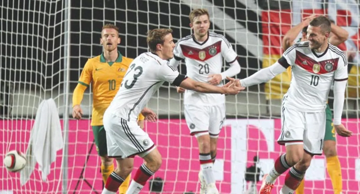 بودولسكي (يمين) يحتفل مع زميله ماكس كروز بهدفه الذي أنقذ ألمانيا أمام أستراليا (إ.ب.أ)
